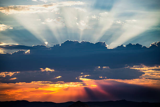 istock Glowing Sun and Sunbeams Behind Clouds 157738595