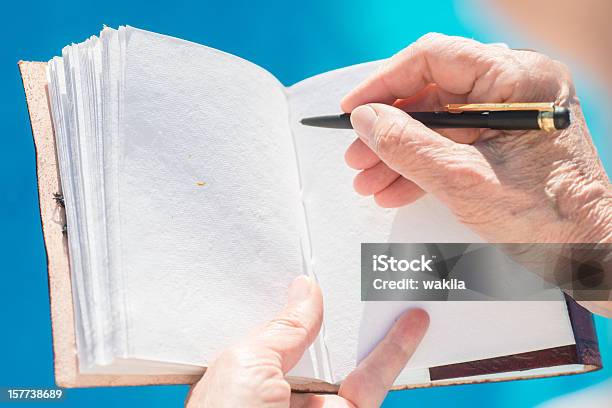 Writing In Empty Leatherbook Diary Or Guestbook At Pool Stock Photo - Download Image Now
