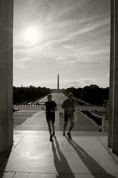 Early on a summer morning, two people jog up the steps of the Lincoln Memorial in Washington DC