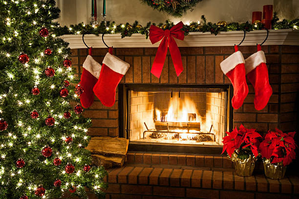Christmas fireplace, tree, and decorations Christmas tree, decorations, lights, fireplace, mantle, hearth poinsettia christmas candle flower stock pictures, royalty-free photos & images