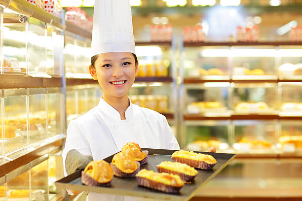 istock pretty young woman working in the bakery 157738997