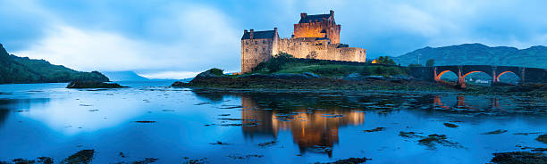 Dornie, Kyle Of Lochalsh Scotland: october 9th of 2023 - Eilean Donan Castle is a picturesque and iconic Scottish landmark, located on a small tidal island at the point where three sea lochs meet in the western Highlands of Scotland. The castle is recognized around the world and is one of the most visited and important attractions in the Scottish Highlands. The castle history is quite dramatic; it was partially destroyed in a Jacobite uprising in 1719 and lay in ruins for about 200 years. It was then restored to its former glory by Lieutenant Colonel John MacRae-Gilstrap, with the restoration completed in 1932