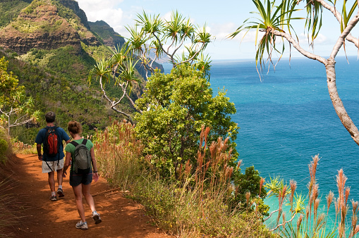 People hike the Kalalau Trail on Kauai's scenic Na Pali coast