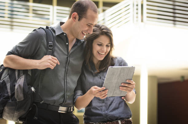 istock Happy Student Couple Looking At Digital Tablet 157739253