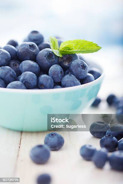 A Blue Bowl Overfilled With Blueberries Stock Photo - Download Image Now - Blueberry, Bowl, Freshness