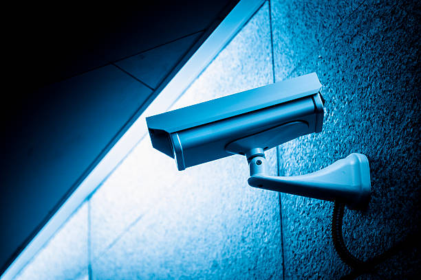 CCTV Security Camera Surveillance cameras in airport, blue toned image, adobe rgb 1998 use. surveillance camera sign stock pictures, royalty-free photos & images