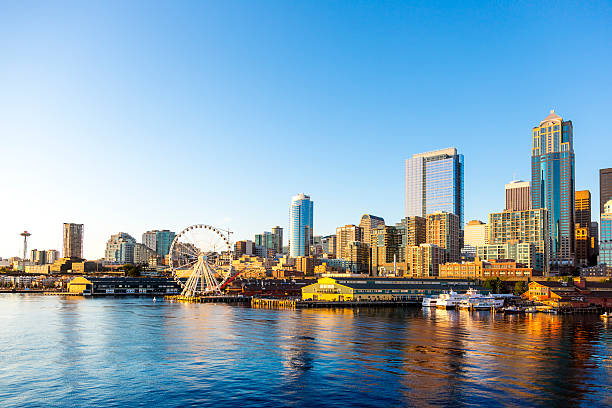 Seattle Downtown Waterfront with Space Needle and Great wheel Beautiful Seattle waterfront art sunset. Includes the Great Wheel ferris wheel which opened in the summer of 2012. puget sound stock pictures, royalty-free photos & images