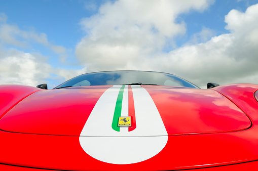 Zandvoort, The Netherlands - June 24, 2012: Ferrari name on a red Ferrari F430 Scuderia sport scar with striping in the colors of the Italian flag. The car is on display during the 2012 Italia a Zandvoort day.