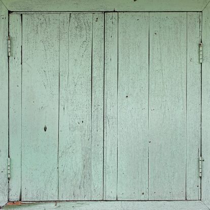 Old painted wooden window shutter background.