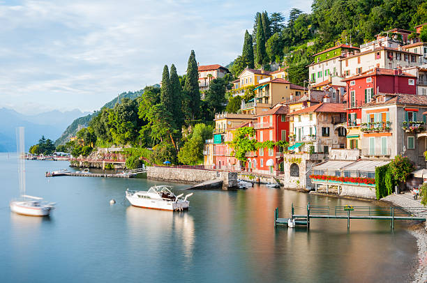 Varenna, Lake Como Panoramic view of Lago di Como in Northern Italy and the beautiful village of Varenna at sunset como italy stock pictures, royalty-free photos & images