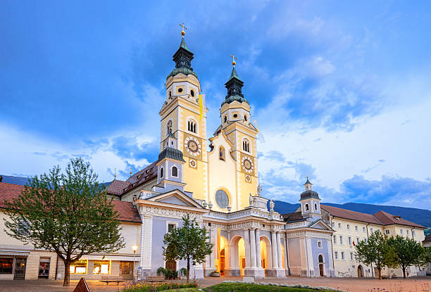 The cathedral and town square of Brixen (Duomo di Bressanone) at dusk under the dramatic clouds of an upcoming thunderstorm. Long exposure.