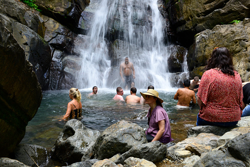Visitors to El Yunque National Forest in Puerto Rico enjoy a swim at La Mina Falls.