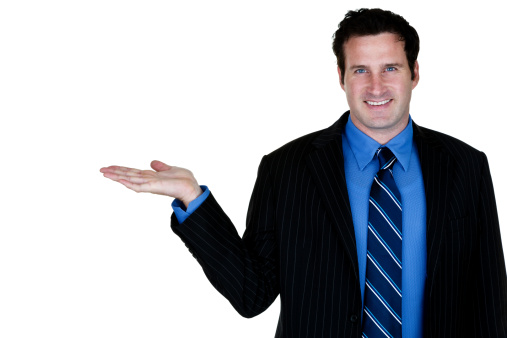 Smiling Businessman isolate on white and holding his hand out for copy space