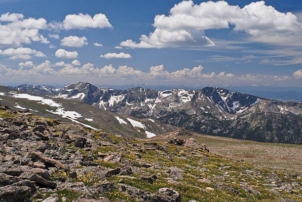 Gathering Clouds Over the Never Summer Range In the Colorado Rockies the typical mid-summer weather pattern is clear skies in the morning with gathering clouds by noon and afternoon thunderstorms. This picture of gathering clouds over the Never Summer Range was taken from Hallett Peak in Rocky Mountain National Park near Estes Park, Colorado, USA. jeff goulden rocky mountain national park stock pictures, royalty-free photos & images