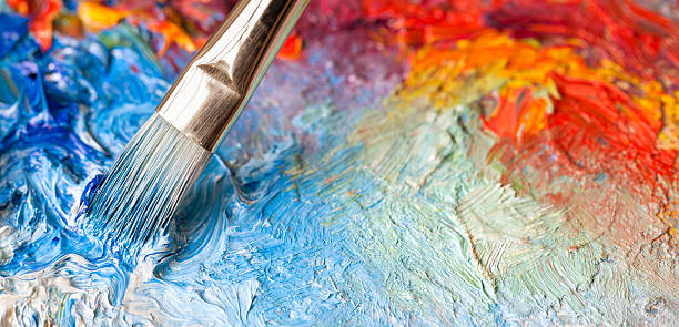 Paintbrush with oil paint on a classical palette Paintbrush with oil paint on a classical palette art and craft equipment photos stock pictures, royalty-free photos & images