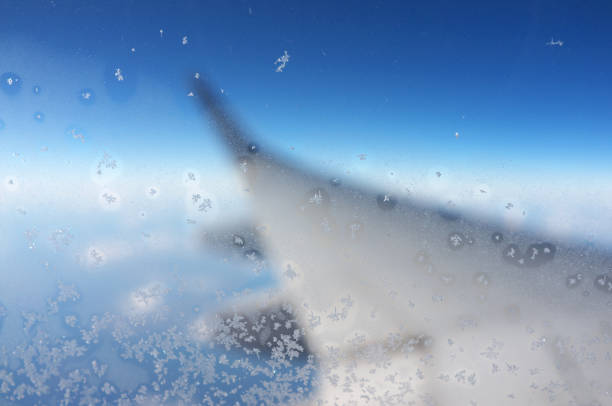 Looking out of an aircraft window, and your view of the world below is somewhat distorted beneath a thin layer of frost. 