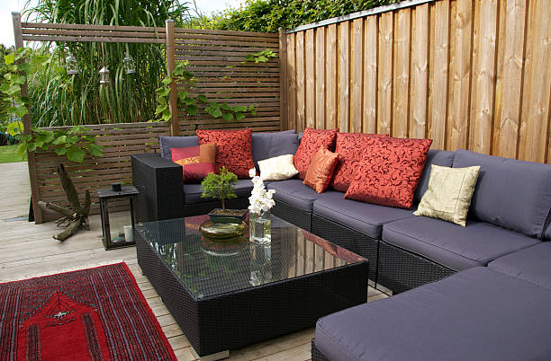 Contemporary patio with large wicker sofa. Garden design A patio with an outdoor wicker sofa.  trellis photos stock pictures, royalty-free photos & images