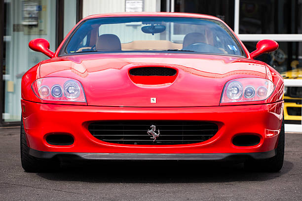 Halifax, Nova Scotia, Canada - September 26, 2012: Outdoors in front of a garage a red Ferrari 575M Maranello.  Front view of vehicle showing Ferrari prancing horse emblem.  The 575M features a V12 engine producing over 500HP.  Its top speed is just over 200 MPH.  In production from 2002-2006 the 575M was then replaced by the 599 GTB.