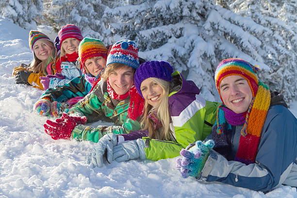 istock Group of happy people lying on snow in forest 157741441