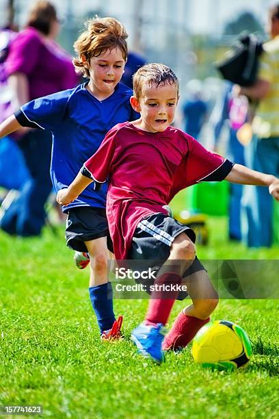 Intense Soccer Playing Boys Battle For Yellow Soccer Ball Stock Photo - Download Image Now