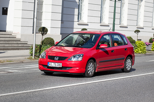 Mummelsee, Germany - Sep 22, 2018: Side view at the white sport Ford hatchback car parked on empty parked near hiking road in the Black Forest - tilt-shift lens used