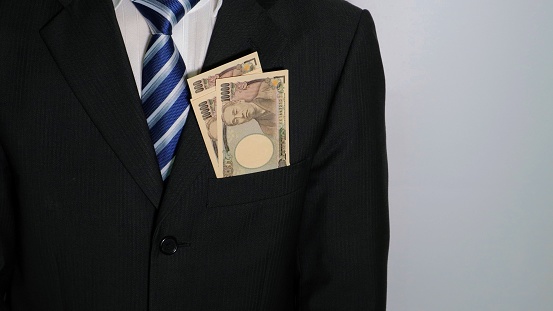 Photo of a businessman with banknotes in his pocket