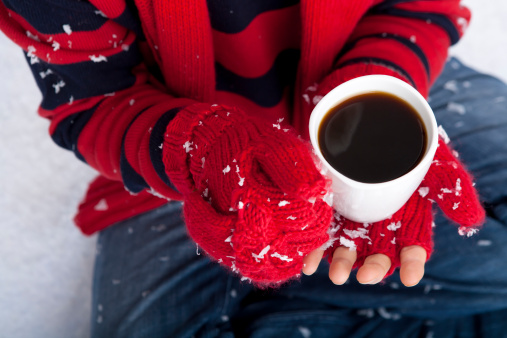 A person enjoying a hot beverage in the winter time