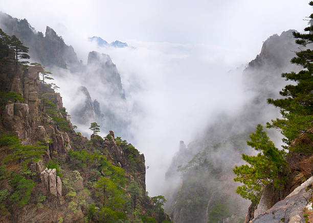 Huangshan Mountain in a sea of clouds Huangshan Mountain in a sea of clouds - Huangshan Mountain (Yellow Mountain), Anhui province, China. huangshan mountains stock pictures, royalty-free photos & images