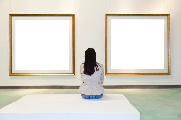 istock One woman looking at white frame in an art gallery 157742074