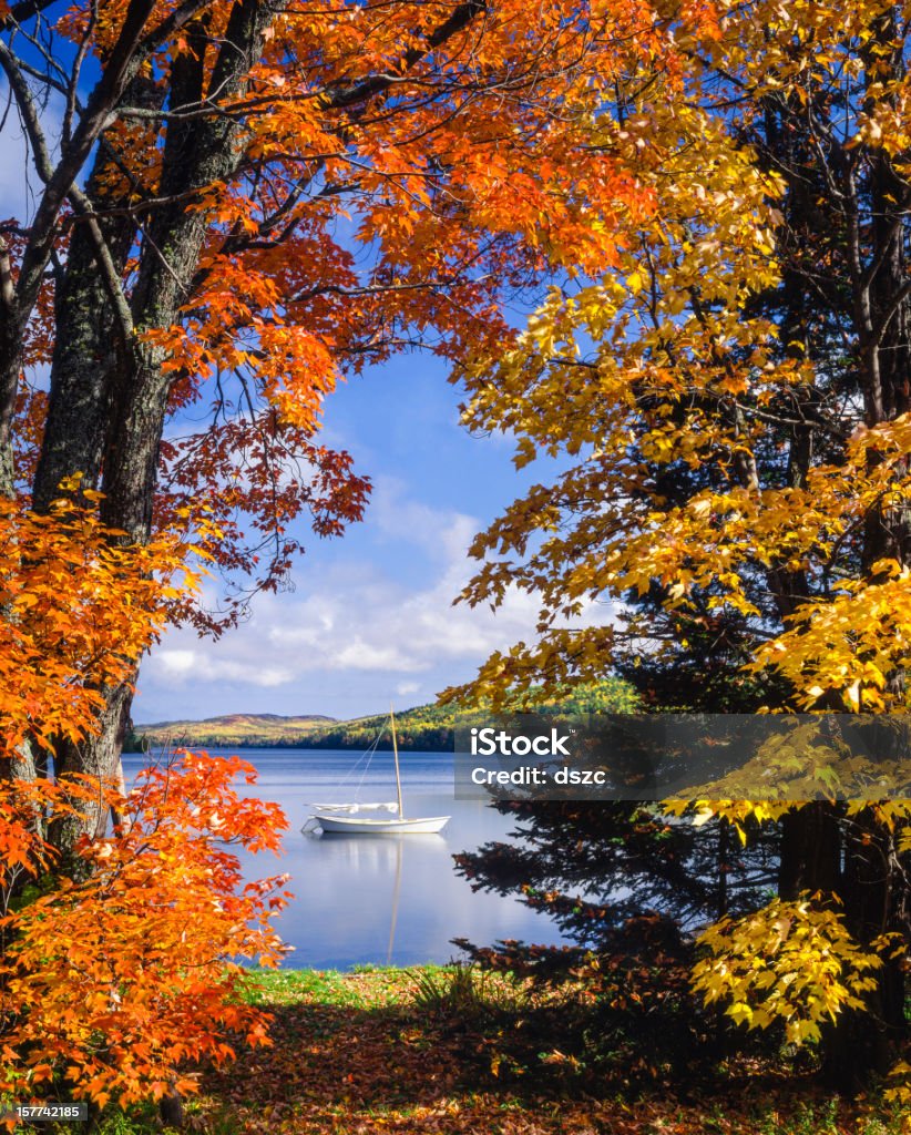 sailboat on lake framed by vibrant autumn foliage autumn at Lake Fanny Hooe near Copper Harbor, Michigan Michigan Stock Photo