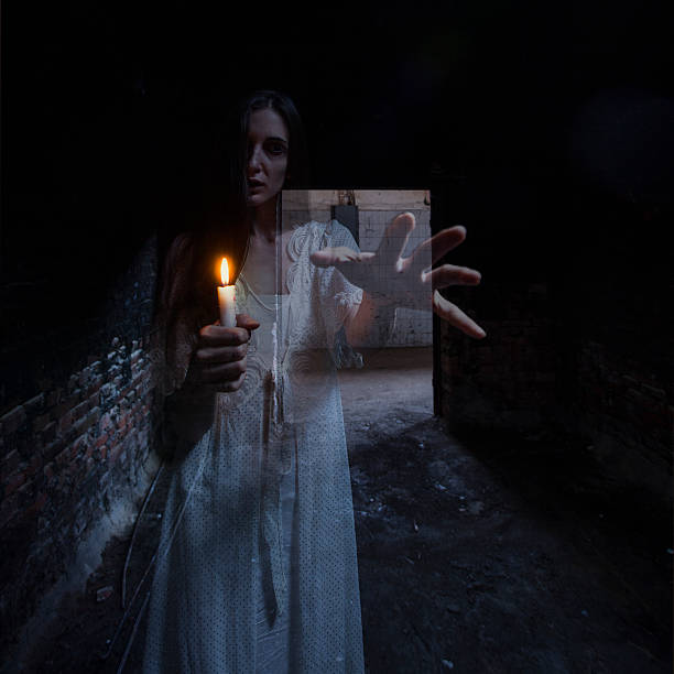 istock Ghostly woman with candle reaching out 157742273