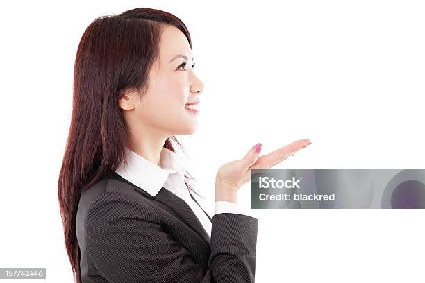 Attractive Chinese Businesswoman Showing Something On White Background Stock Photo - Download Image Now