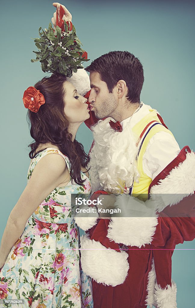 Santa and Mrs. Clause Geeky Santa clause with mistletoe over head for a kiss Mistletoe Stock Photo