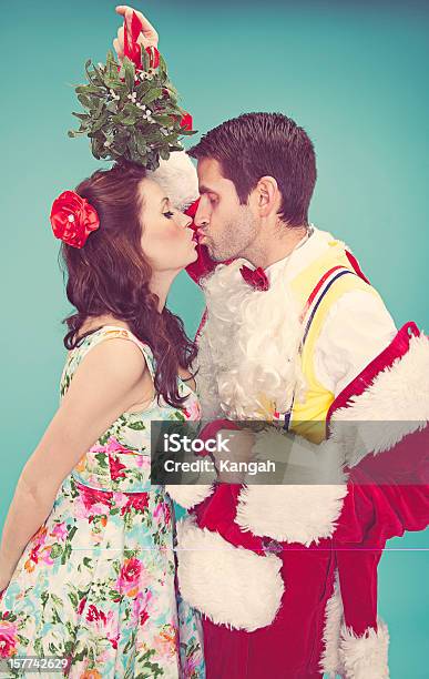 Santa And Mrs Clause Stock Photo - Download Image Now - Mistletoe, Old-fashioned, Kissing