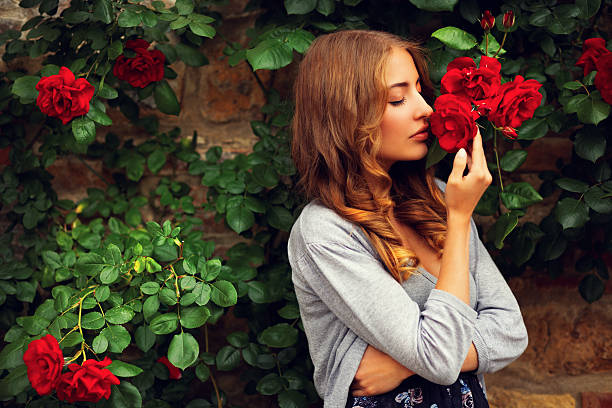 istock girl smelling roses 157742640