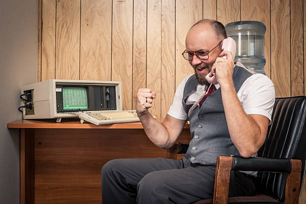 istock Happy 1980's sales man worker nerd  on phone at cubicle 157742676
