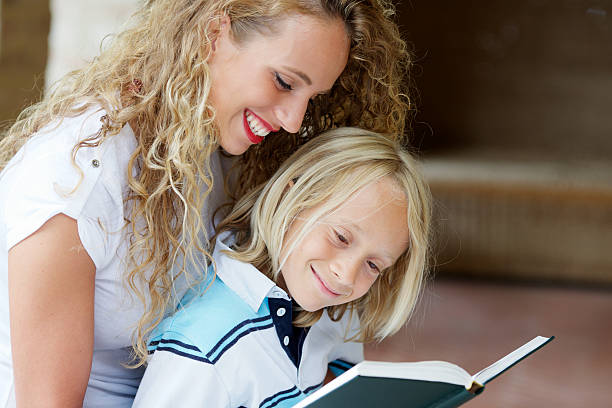 istock Woman reading book to little boy 157742776