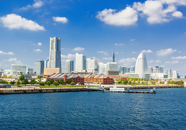 Yokohama The skyline of Yokohama with the Landmark Tower, Queen's Square and the ferries wheel with the Aka-Rengo Soko warehouse on a beautiful October day. kanagawa prefecture photos stock pictures, royalty-free photos & images