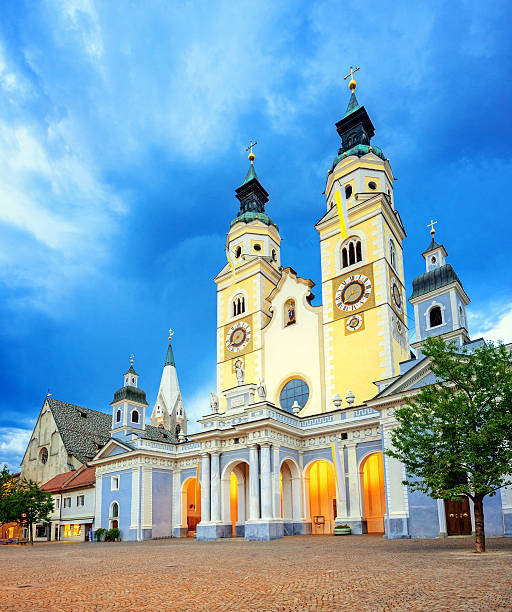 The cathedral and town square of Brixen (Duomo di Bressanone) at dusk under the dramatic clouds of an upcoming thunderstorm. Long exposure.