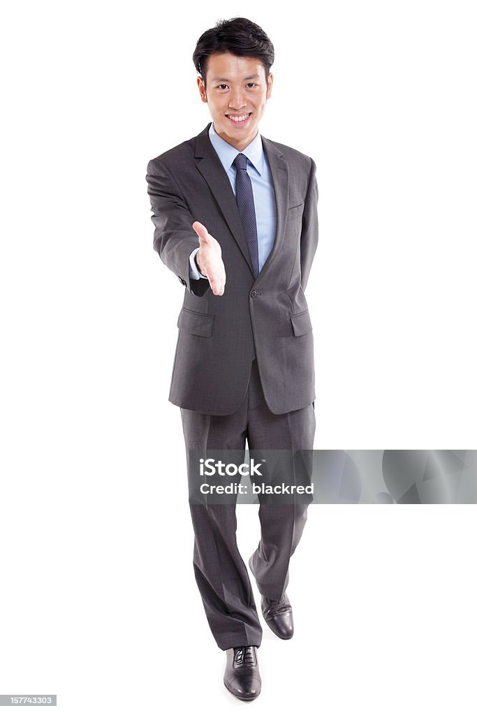 Asian Businessman Handshake Young Asian businessman showing a welcome handshake, isolated on white background. Handshake Stock Photo