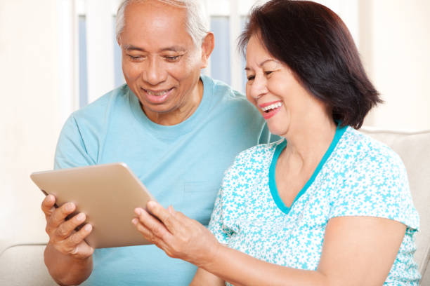 istock Happy Senior Asian Couple with Tablet 157743623