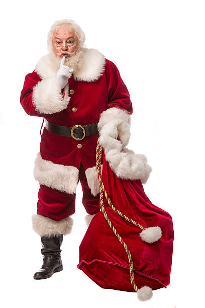 pictures of Real Santa Claus Has A Gift Bag Santa Claus carrying his toy bag. This stock image is a vertical composition isolated on white santa claus expressions shhh stock pictures, royalty-free photos & images