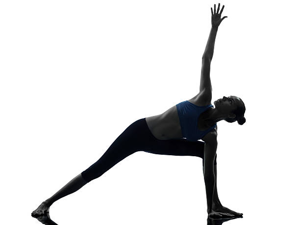 istock woman exercising stretching triangle pose yoga 157748477