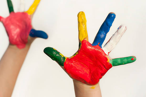 istock Hands of a child covered in colorful paints 157750521
