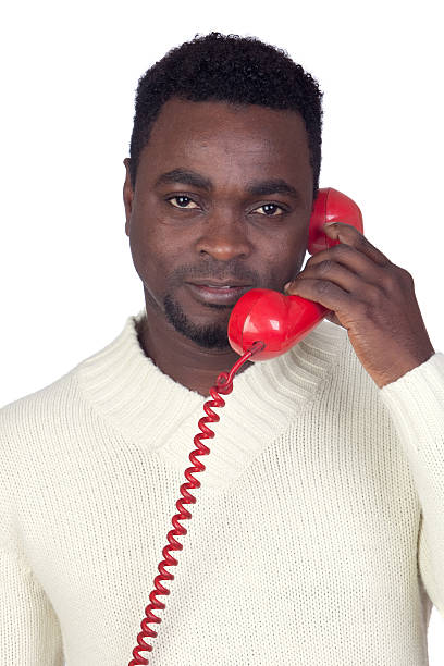 istock Attractive african man with a red phone 157751320