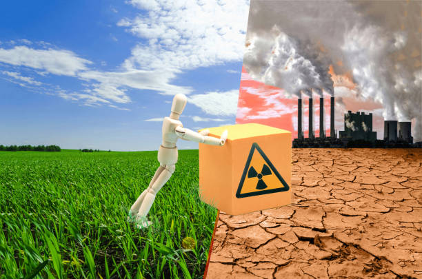 istock The concept of environmental pollution by radioactive materials. A human dummy pushes a container with radioactive materials 1577531423