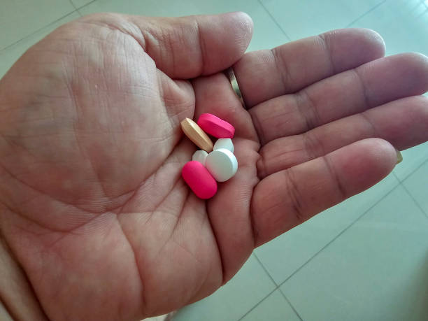 istock Close up photo of various medicines on hand 1577568372