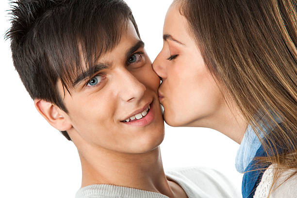 istock Girl kissing boy on cheek. 157757538