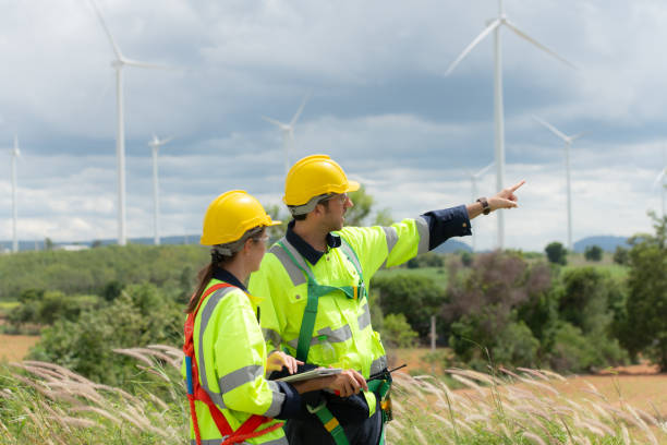 istock Engineer and worker discussing the project on the background of wind turbines 1577575705