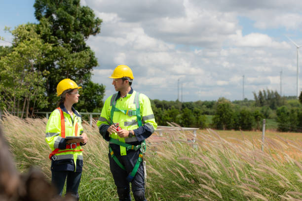 istock Engineer and worker discussing the project on the background of wind turbines 1577575706